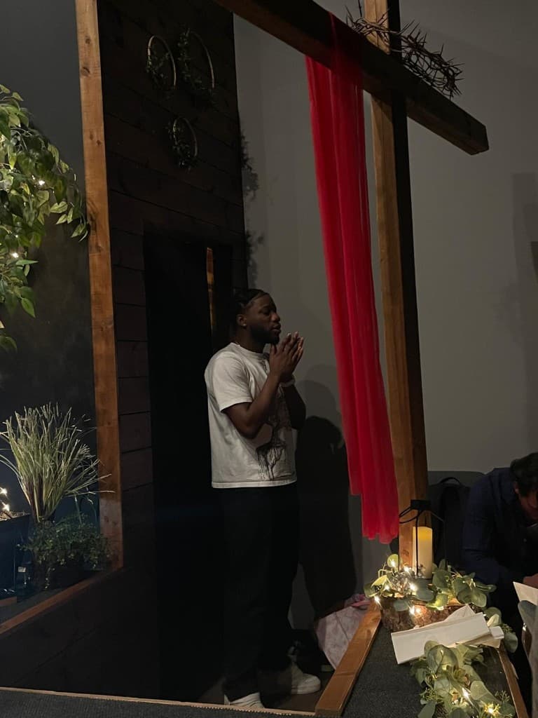 Valentino praying at the cross